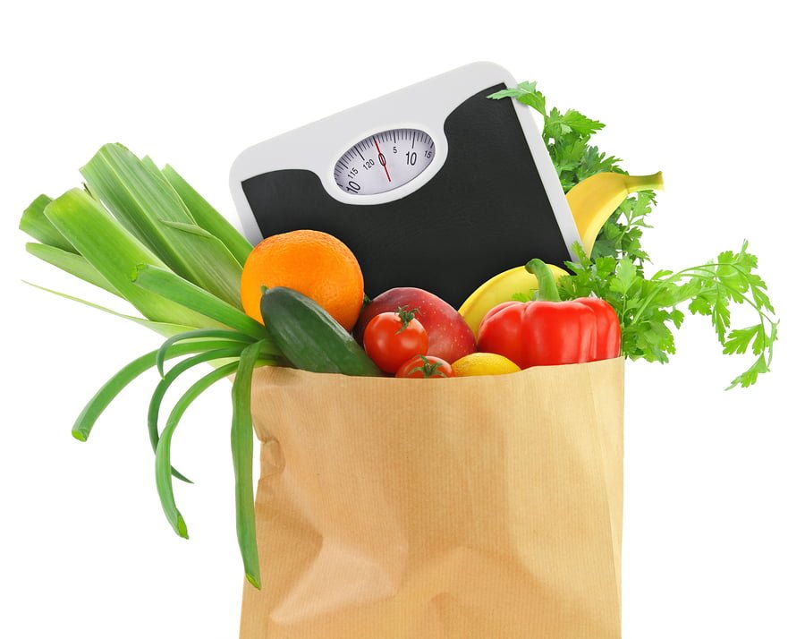 Fresh groceries in a paper bag with weight scale