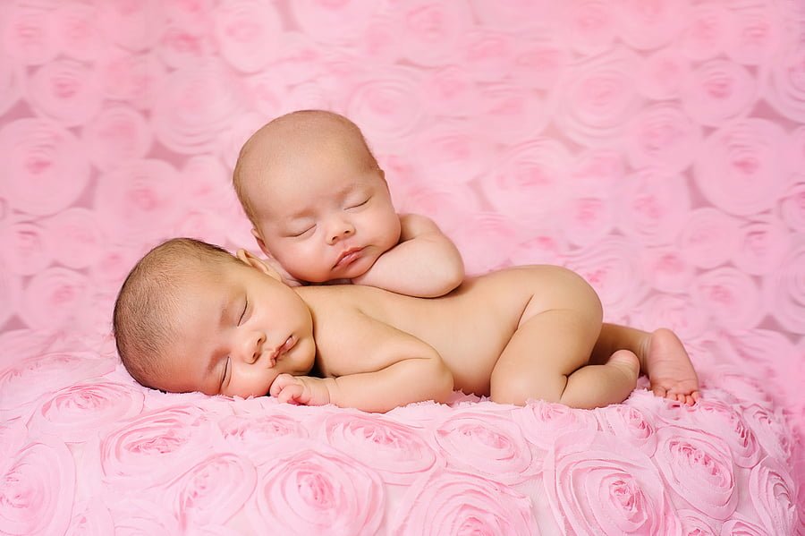 Fraternal Twin Newborn Baby Girls Sleeping On Pink Rose Fabric - AskDrManny