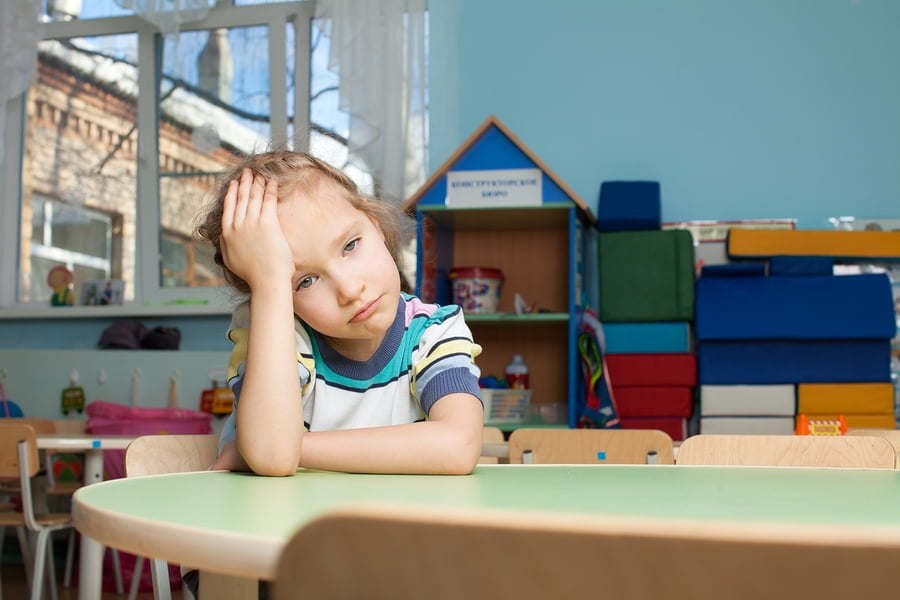 Sad child in kindergarten. Depression girl in nursery school