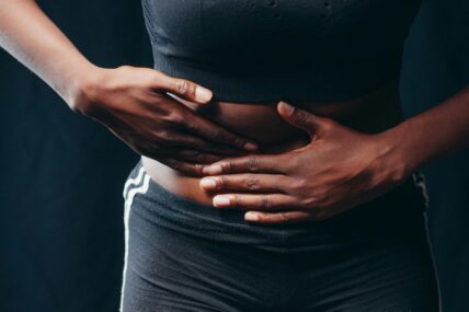 Person holding right abdomen.