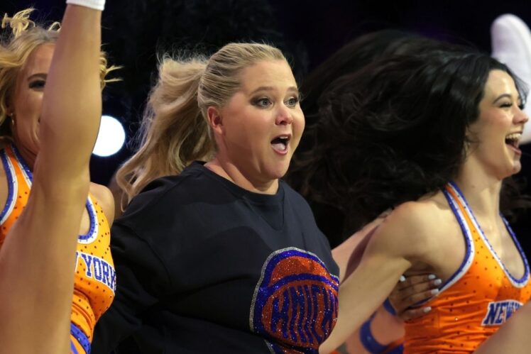 American actress and comedian Amy Schumer dances with members of the Knicks city dancers